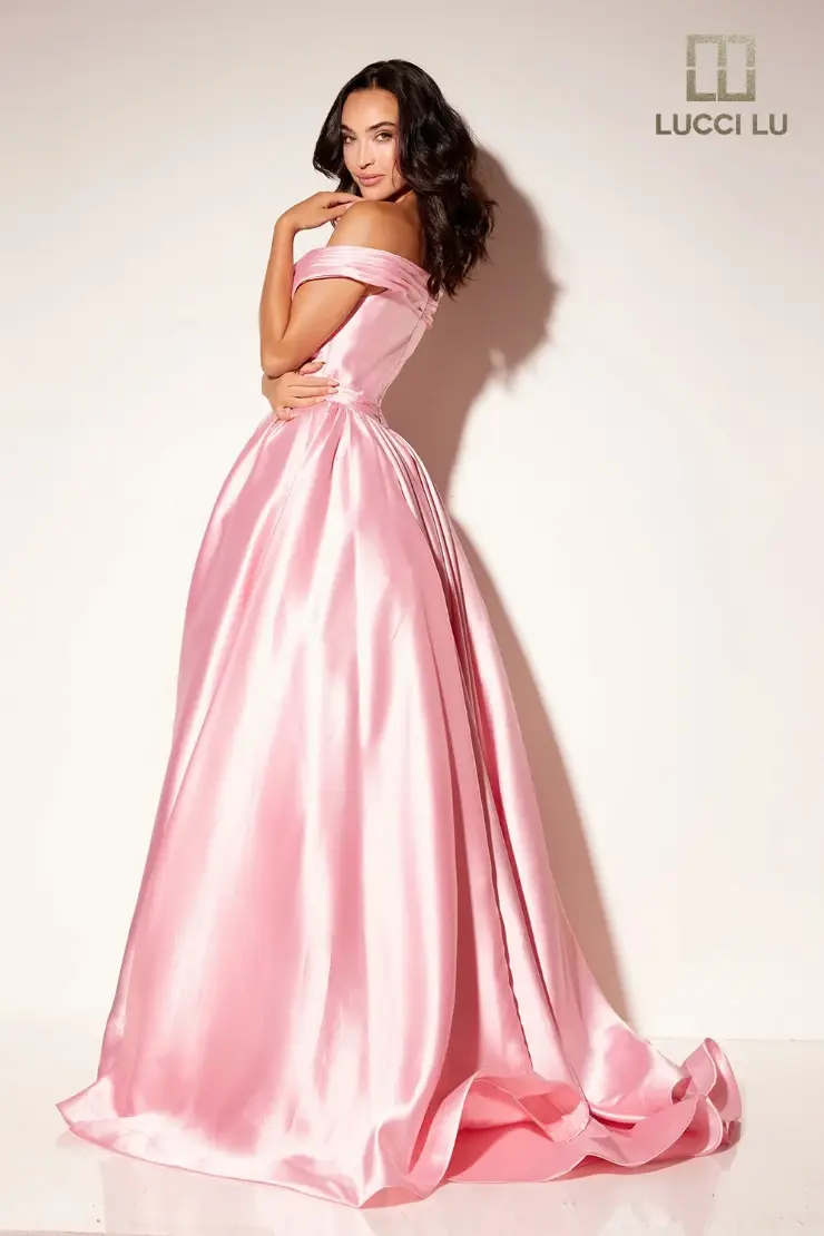 model is wearing an off the shoulder pink ball gown dress