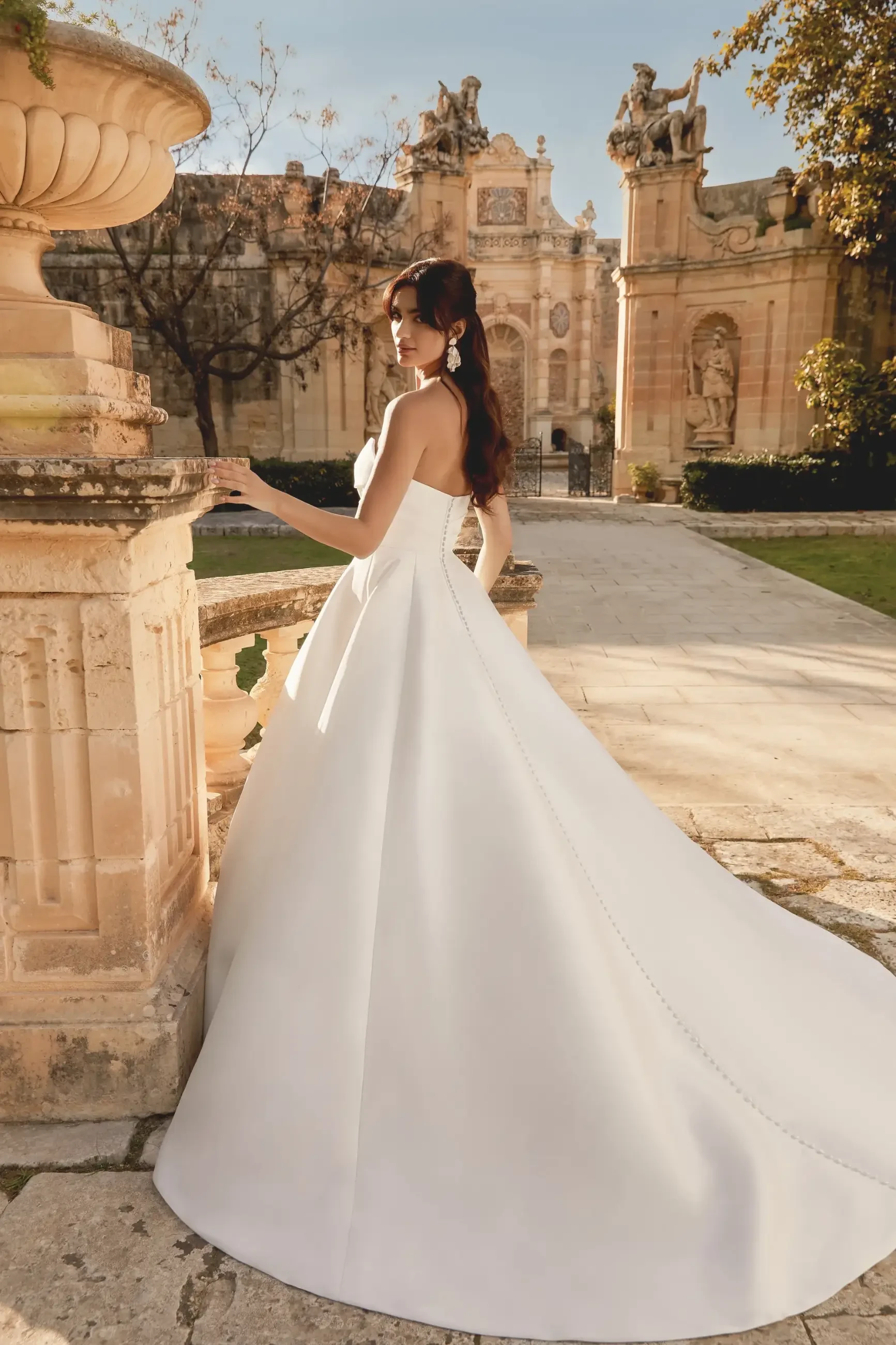 model is wearing a strapless a-line bridal gown