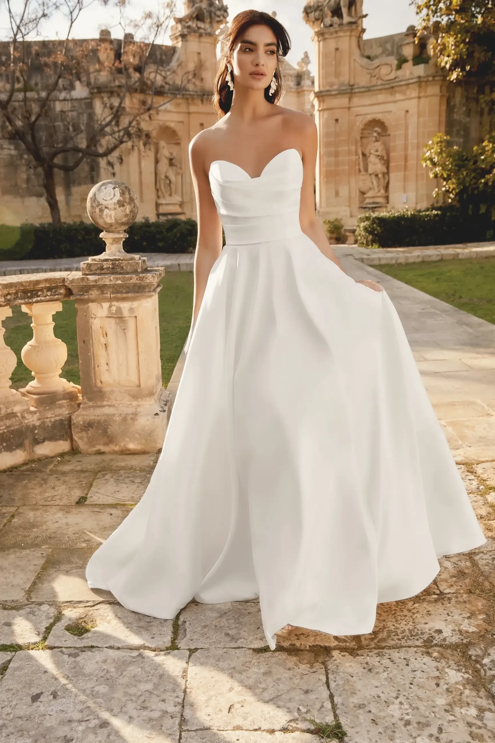 model is wearing a strapless a-line bridal gown