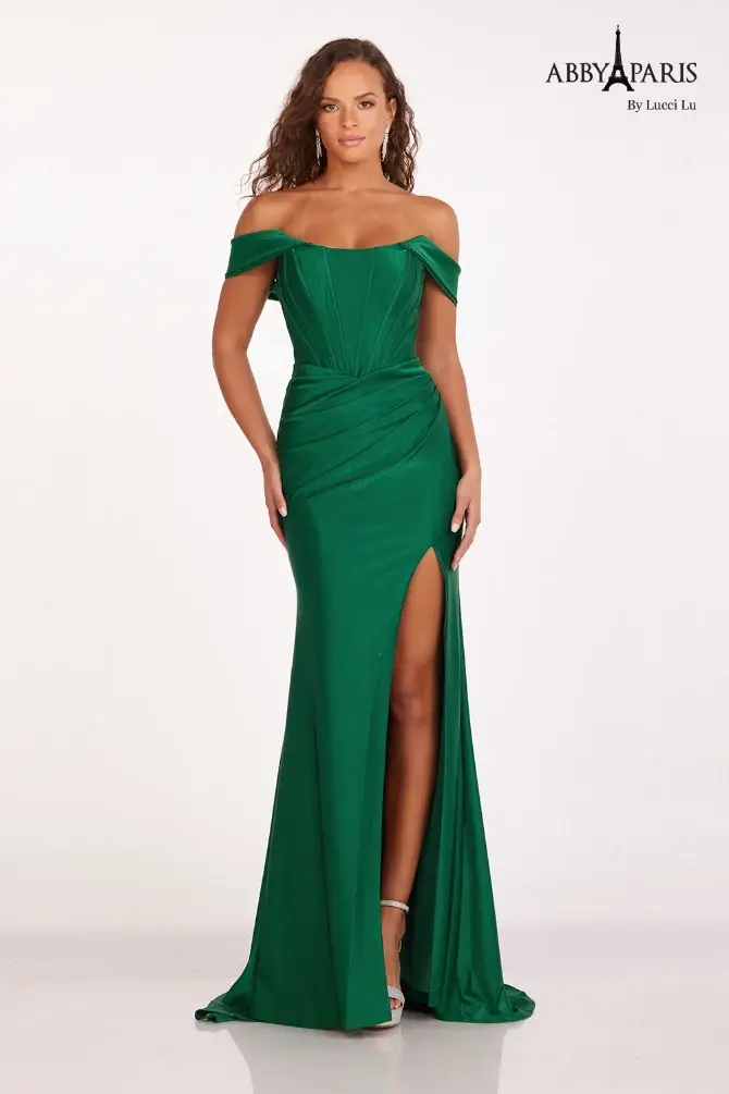 model is wearing an off the shoulder emerald green prom dress