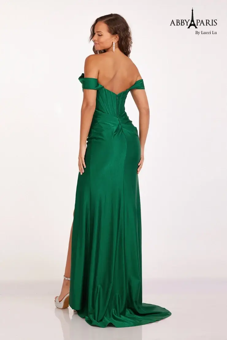 model is wearing an off the shoulder emerald green prom dress