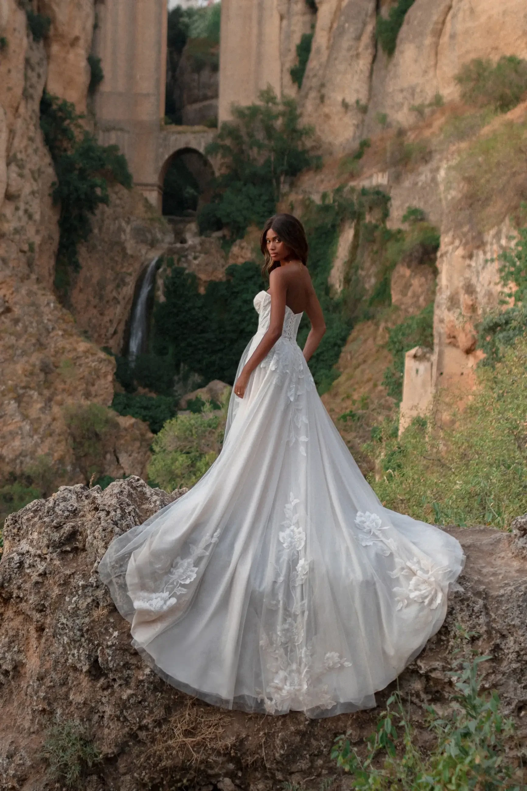 model is wearing a strapless ball gown wedding dress