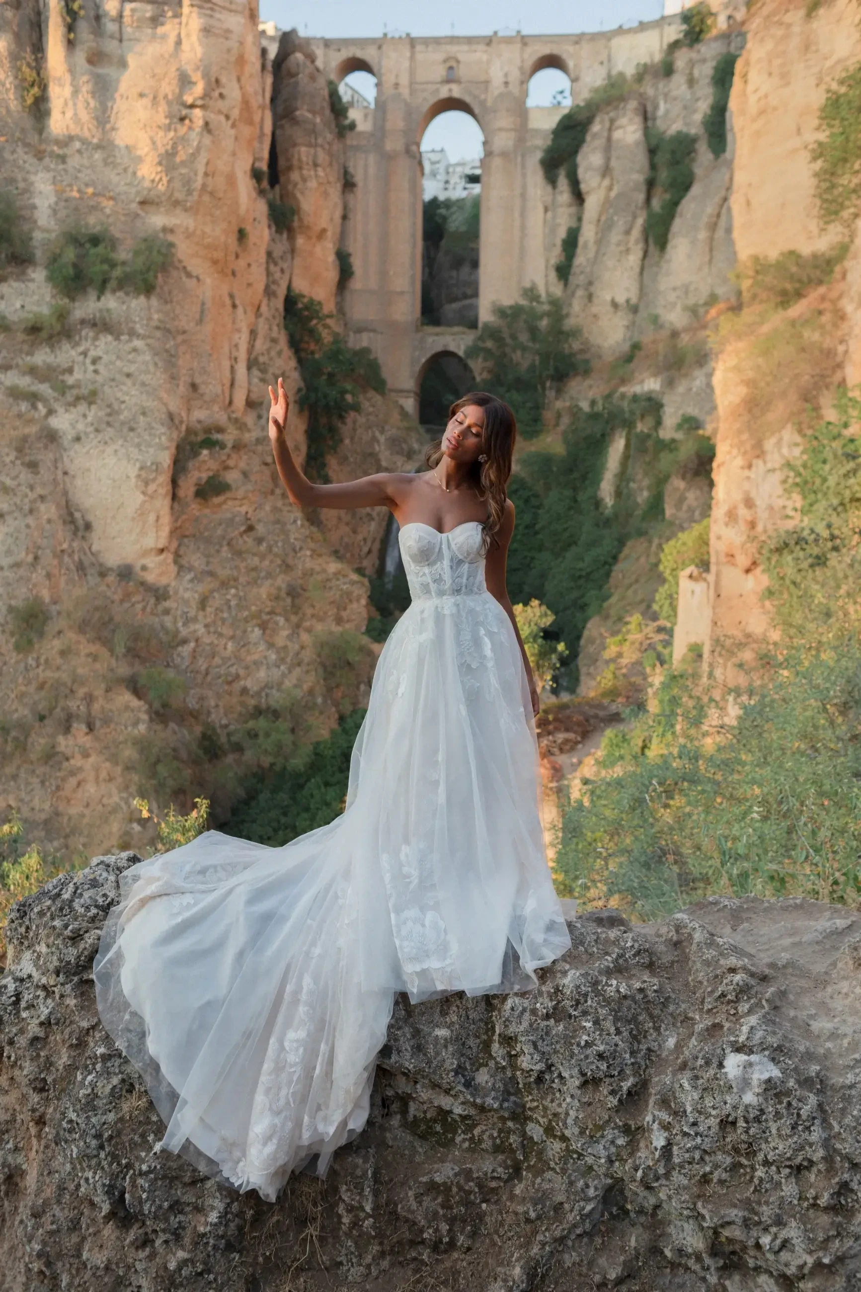 model is wearing a strapless ball gown wedding dress