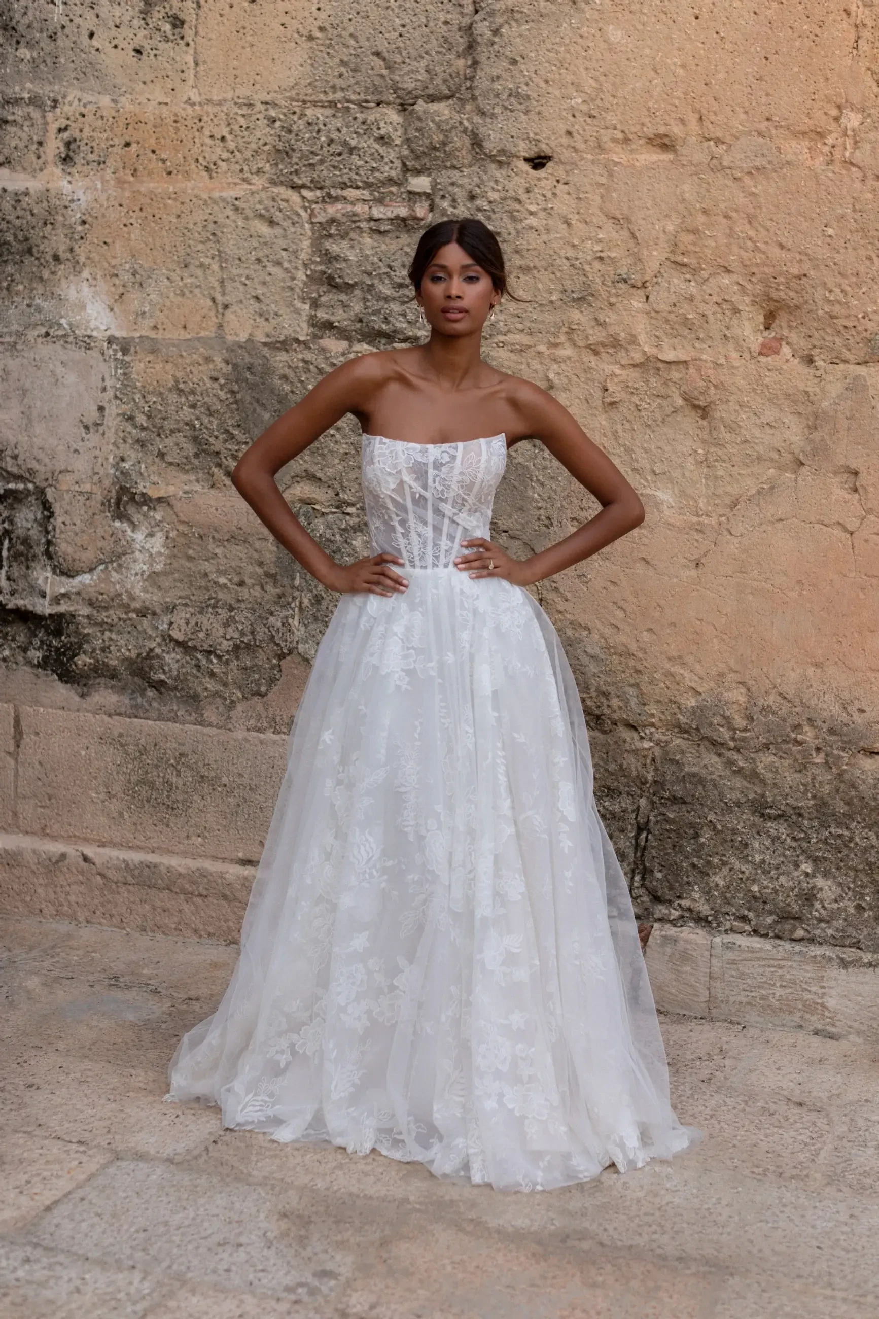 model is wearing a scoop neck a-line wedding dress