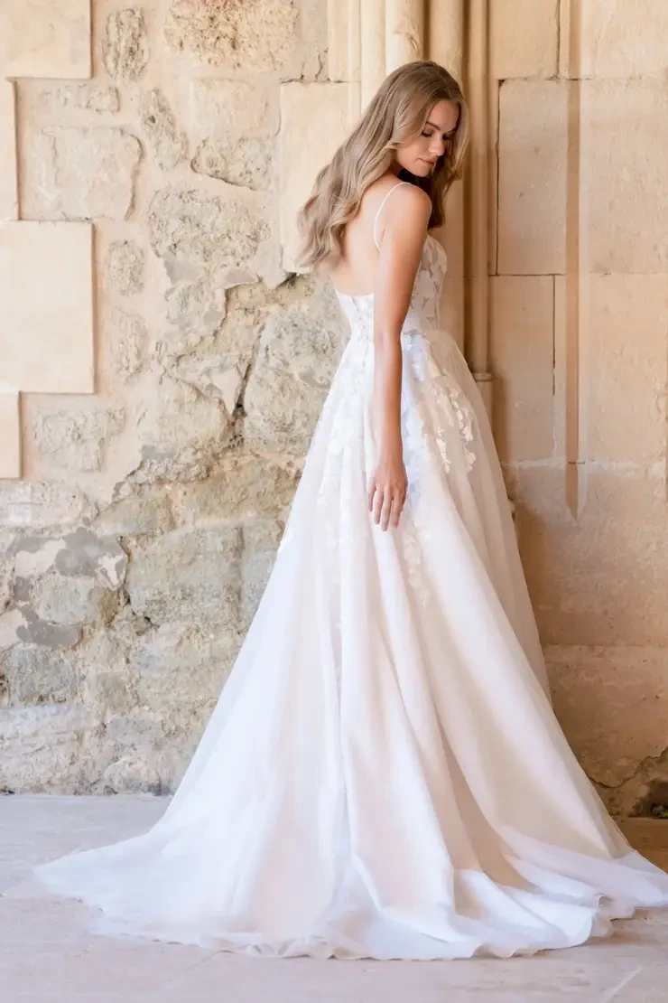 Model is wearing an a-line tulle and lace wedding dress by allure romance